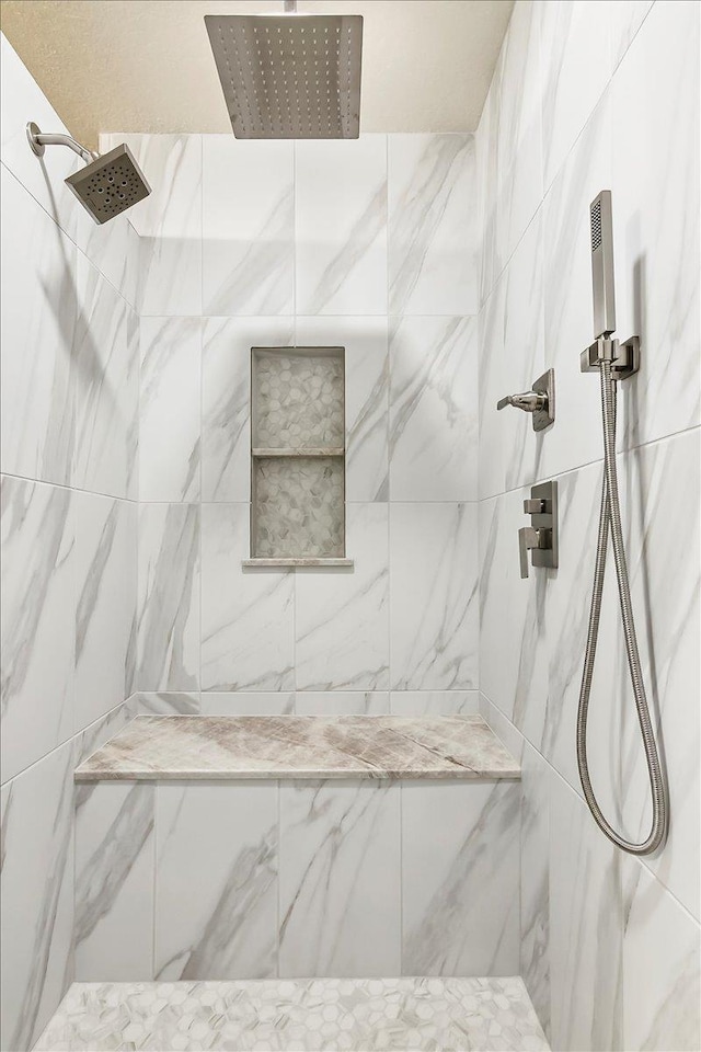 bathroom with a tile shower