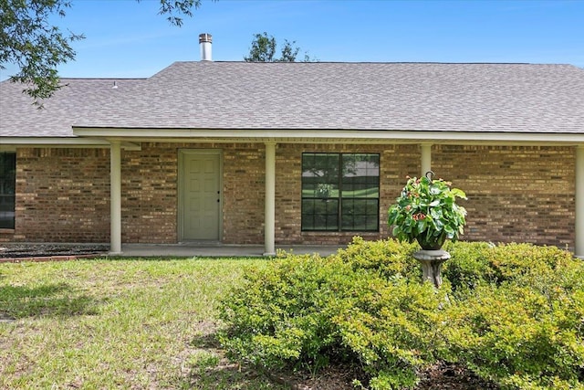 back of house with a lawn