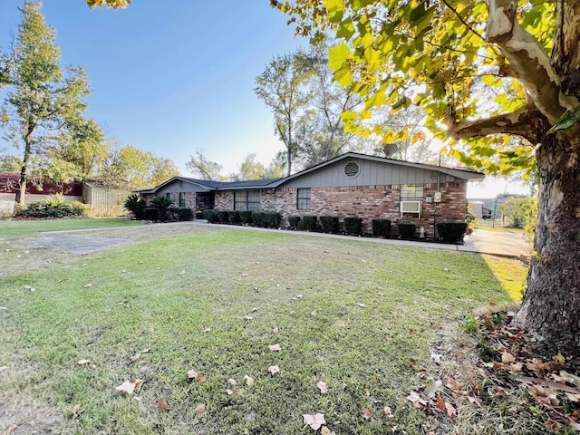 view of side of home with a yard