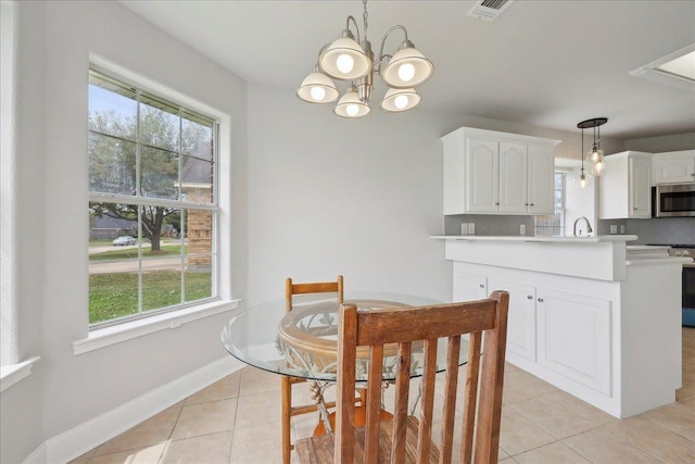 dining area with baseboards, visible vents, an inviting chandelier, and light tile patterned floors