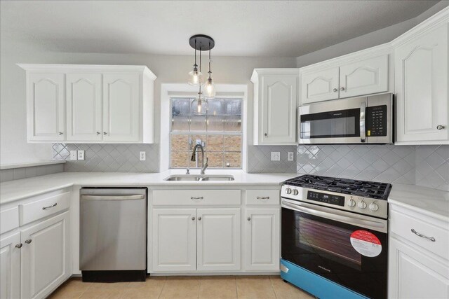 kitchen with white cabinets, a sink, and stainless steel appliances