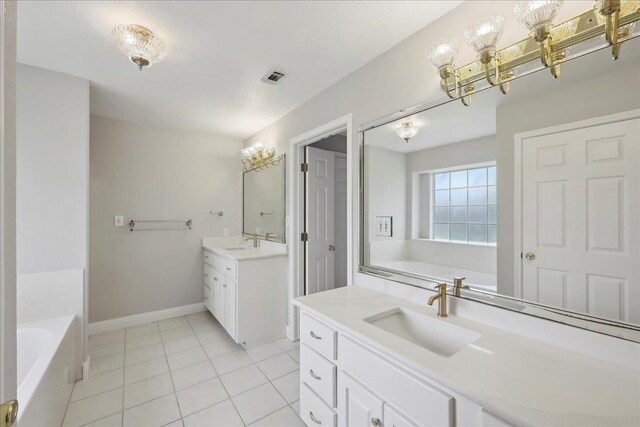 full bathroom featuring a sink, a bath, two vanities, and visible vents