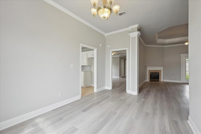 unfurnished living room featuring ornamental molding, baseboards, and a chandelier