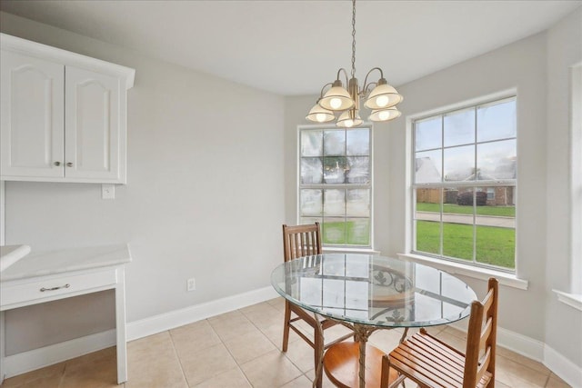 dining space featuring an inviting chandelier, light tile patterned floors, and baseboards