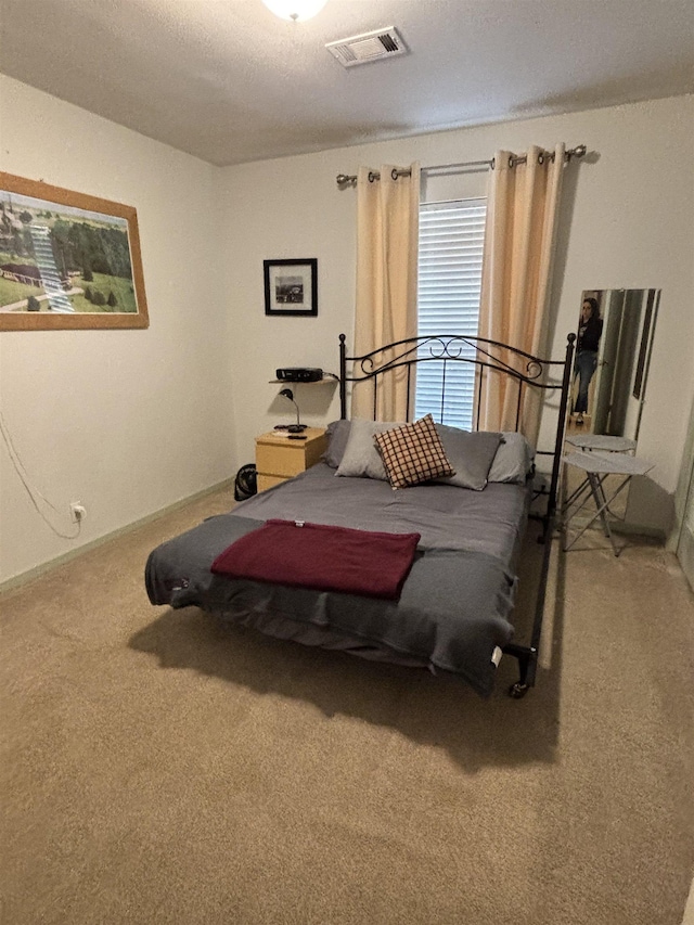 bedroom featuring carpet flooring and visible vents