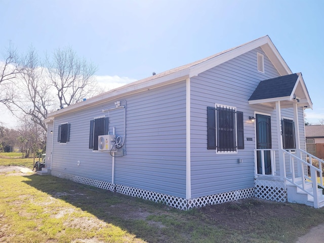 view of home's exterior with ac unit and a lawn