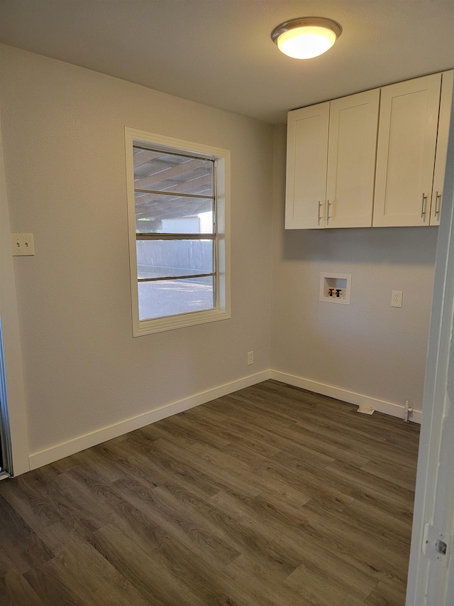 clothes washing area with cabinets, hookup for a washing machine, and dark hardwood / wood-style floors