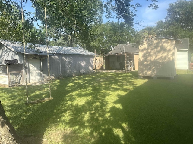 5041 9th St, Port Arthur, TX 77642 - view of green lawn featuring an outdoor structure and an outbuilding
