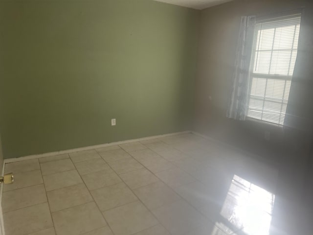 5041 9th St, Port Arthur, TX 77642 - spare room featuring baseboards and light tile patterned floors