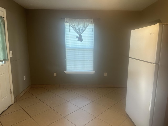 5041 9th St, Port Arthur, TX 77642 - unfurnished dining area with light tile patterned flooring and baseboards