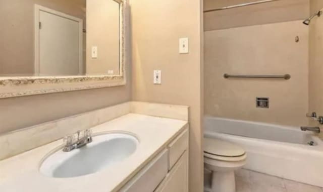 bathroom featuring shower / bath combination, toilet, vanity, and tile patterned floors