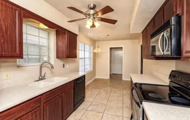 kitchen with a sink, dishwasher, range with electric cooktop, light countertops, and stainless steel microwave
