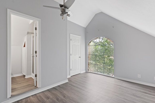 930 Llano St, Port Neches, TX 77651 - unfurnished bedroom with wood finished floors, vaulted ceiling, a ceiling fan, and baseboards