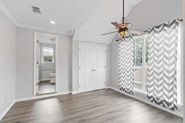 930 Llano St, Port Neches, TX 77651 - unfurnished bedroom featuring wood finished floors, baseboards, a ceiling fan, a closet, and crown molding
