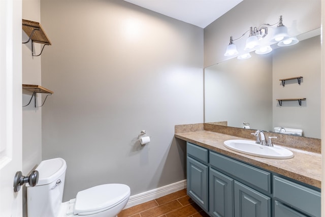 5269 Fairview Dr, Orange, TX 77630 - bathroom with toilet, baseboards, vanity, and wood tiled floors