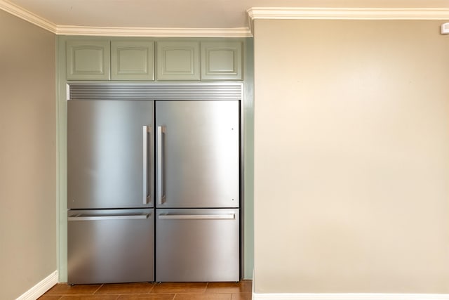 5269 Fairview Dr, Orange, TX 77630 - detailed view of built in refrigerator, green cabinets, ornamental molding, and baseboards