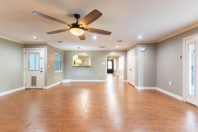 5269 Fairview Dr, Orange, TX 77630 - unfurnished living room featuring ceiling fan, arched walkways, plenty of natural light, crown molding, and recessed lighting