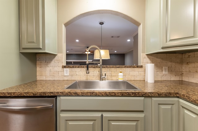 5269 Fairview Dr, Orange, TX 77630 - kitchen featuring stainless steel dishwasher, a sink, arched walkways, and dark countertops