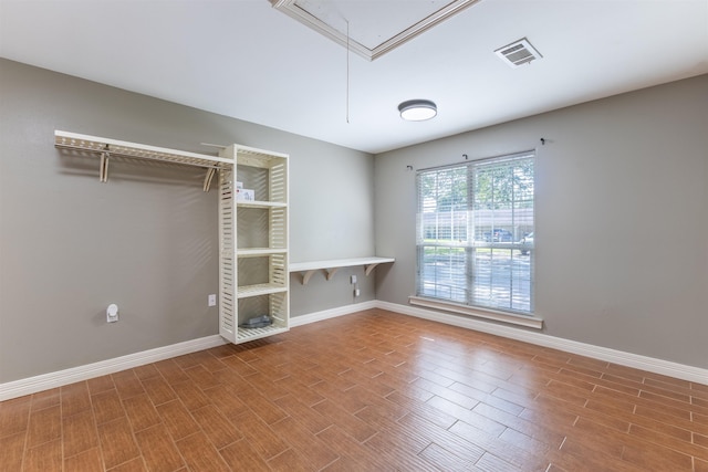 5269 Fairview Dr, Orange, TX 77630 - spare room with attic access, wood finished floors, and baseboards