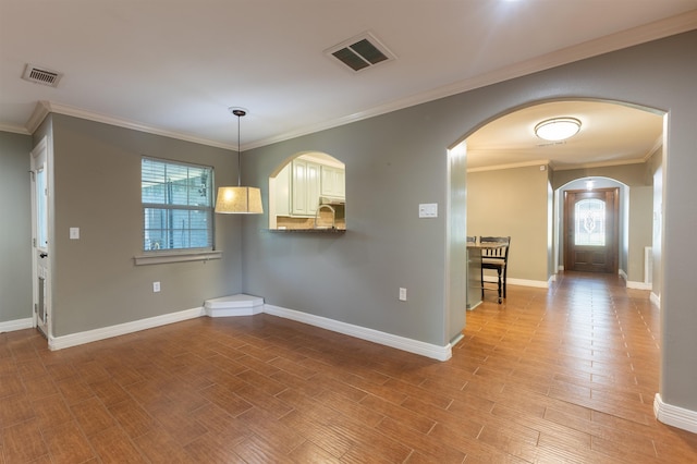5269 Fairview Dr, Orange, TX 77630 - unfurnished dining area with ornamental molding, wood finished floors, baseboards, and arched walkways
