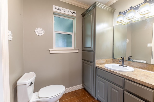 5269 Fairview Dr, Orange, TX 77630 - half bathroom with ornamental molding, baseboards, toilet, vanity, and wood tiled floors