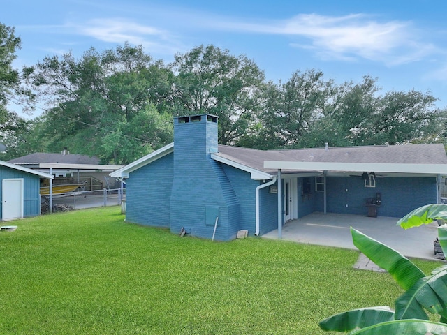5269 Fairview Dr, Orange, TX 77630 - back of property with a patio, a chimney, a storage shed, and an outdoor structure