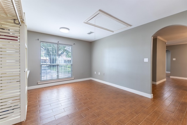 5269 Fairview Dr, Orange, TX 77630 - empty room featuring attic access, arched walkways, baseboards, and wood finished floors
