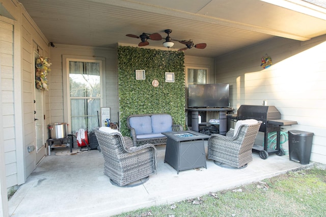 view of patio / terrace with ceiling fan, grilling area, and an outdoor living space with a fire pit