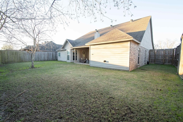 rear view of house with a lawn