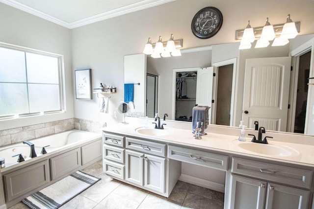 bathroom with vanity, tile patterned floors, a bathtub, and ornamental molding