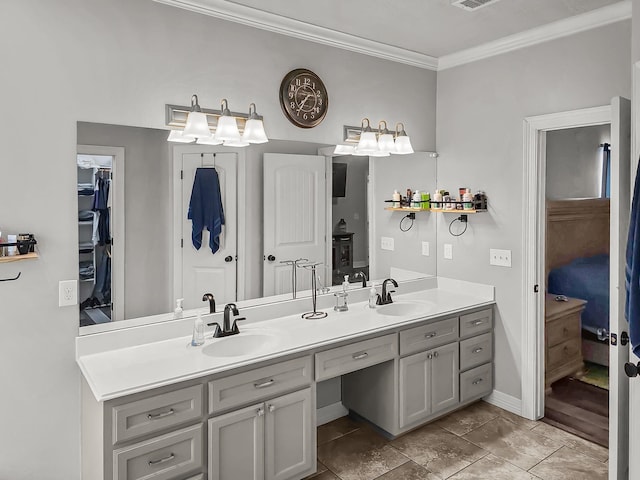 full bathroom featuring double vanity, visible vents, ornamental molding, and a sink