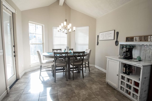 dining space featuring vaulted ceiling with beams, a healthy amount of sunlight, a textured ceiling, and a chandelier