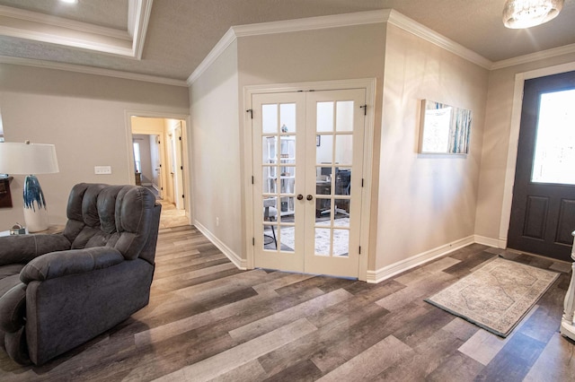 entrance foyer featuring hardwood / wood-style flooring, french doors, and ornamental molding