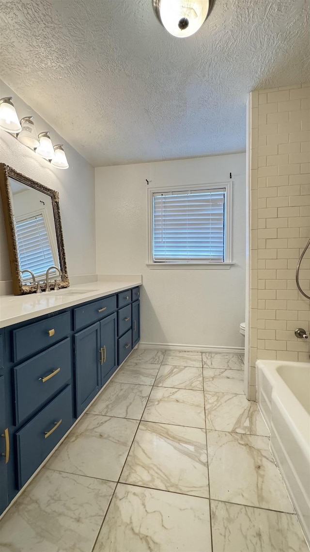 4801 Kent Ave, Groves, TX 77619 - bathroom with marble finish flooring, vanity, toilet, baseboards, and washtub / shower combination