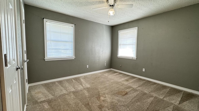 4801 Kent Ave, Groves, TX 77619 - unfurnished room featuring carpet flooring, a textured ceiling, ceiling fan, and baseboards