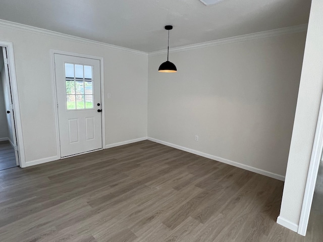 unfurnished dining area featuring dark hardwood / wood-style flooring and ornamental molding