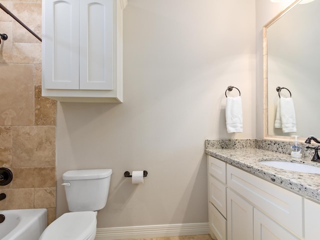 full bathroom featuring tiled shower / bath, vanity, and toilet