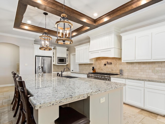 kitchen featuring sink, a spacious island, decorative backsplash, white cabinets, and appliances with stainless steel finishes