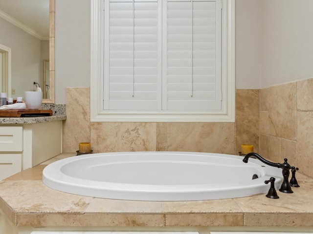 bathroom featuring a bath, vanity, and ornamental molding