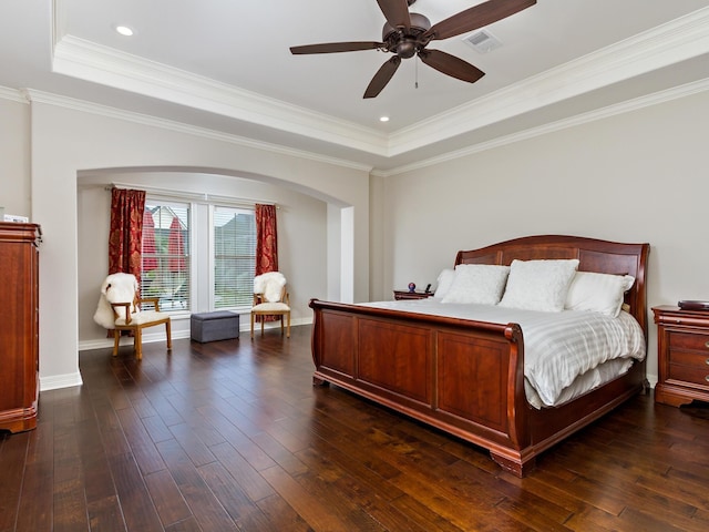 bedroom featuring a raised ceiling, ceiling fan, and crown molding