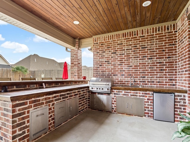 view of patio / terrace featuring area for grilling and sink