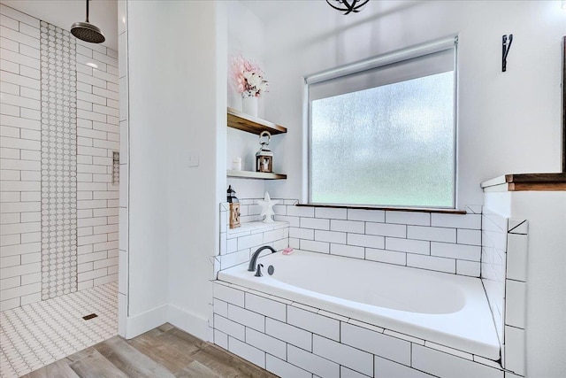 4801 Candlewick Dr, Orange, TX 77630 - bathroom with tiled shower, a garden tub, and wood finished floors