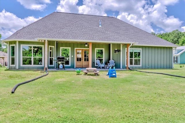 4801 Candlewick Dr, Orange, TX 77630 - back of house featuring board and batten siding, a shingled roof, and a lawn