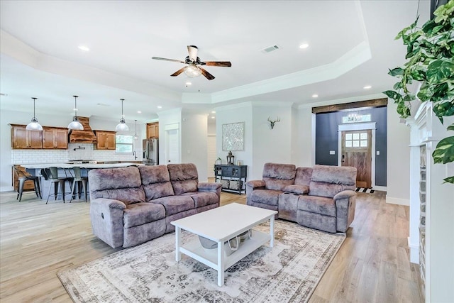 4801 Candlewick Dr, Orange, TX 77630 - living room featuring a ceiling fan, light wood finished floors, recessed lighting, a raised ceiling, and ornamental molding