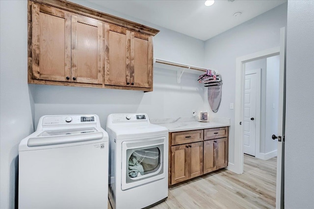 4801 Candlewick Dr, Orange, TX 77630 - laundry room featuring independent washer and dryer, cabinet space, and light wood-style flooring
