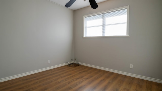 unfurnished room featuring ceiling fan and dark wood-type flooring