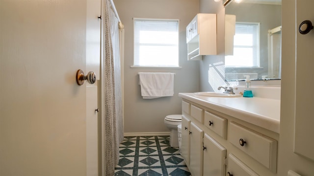 bathroom with tile patterned flooring, vanity, a shower with shower curtain, and toilet