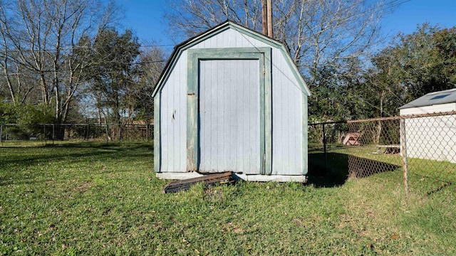 view of outbuilding featuring a yard