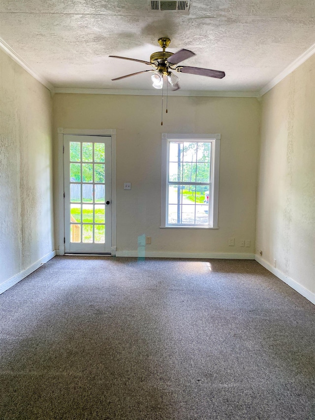 spare room featuring crown molding, carpet, and ceiling fan