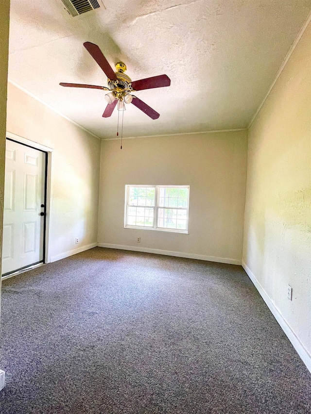 carpeted empty room featuring a textured ceiling, baseboards, a ceiling fan, and visible vents